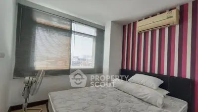 Modern bedroom with striped accent wall and air conditioning