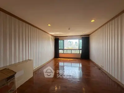 Spacious empty living room with city view and wooden flooring