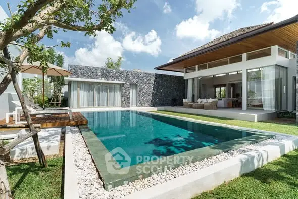 Luxurious modern villa with private pool and lush garden, perfect for relaxation and entertainment.
