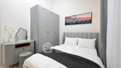 Cozy bedroom with stylish decor and modern furniture, featuring a comfortable bed and elegant wardrobe.