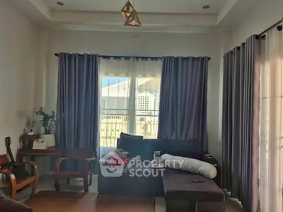 Cozy living room with modern furniture and large windows for natural light.