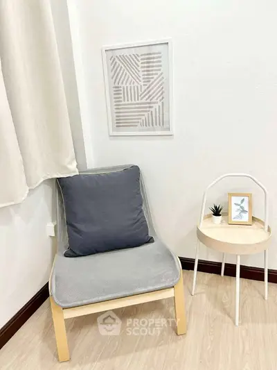 Cozy corner with modern chair and side table in minimalist interior design.