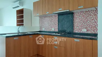 Modern kitchen with sleek wooden cabinets and stylish mosaic backsplash