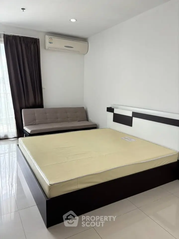 Spacious bedroom with modern furnishings and natural light