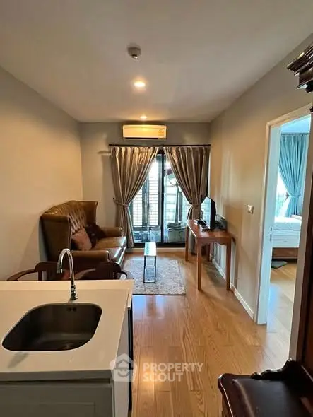 Modern living room with open layout and cozy furnishings in a stylish apartment.
