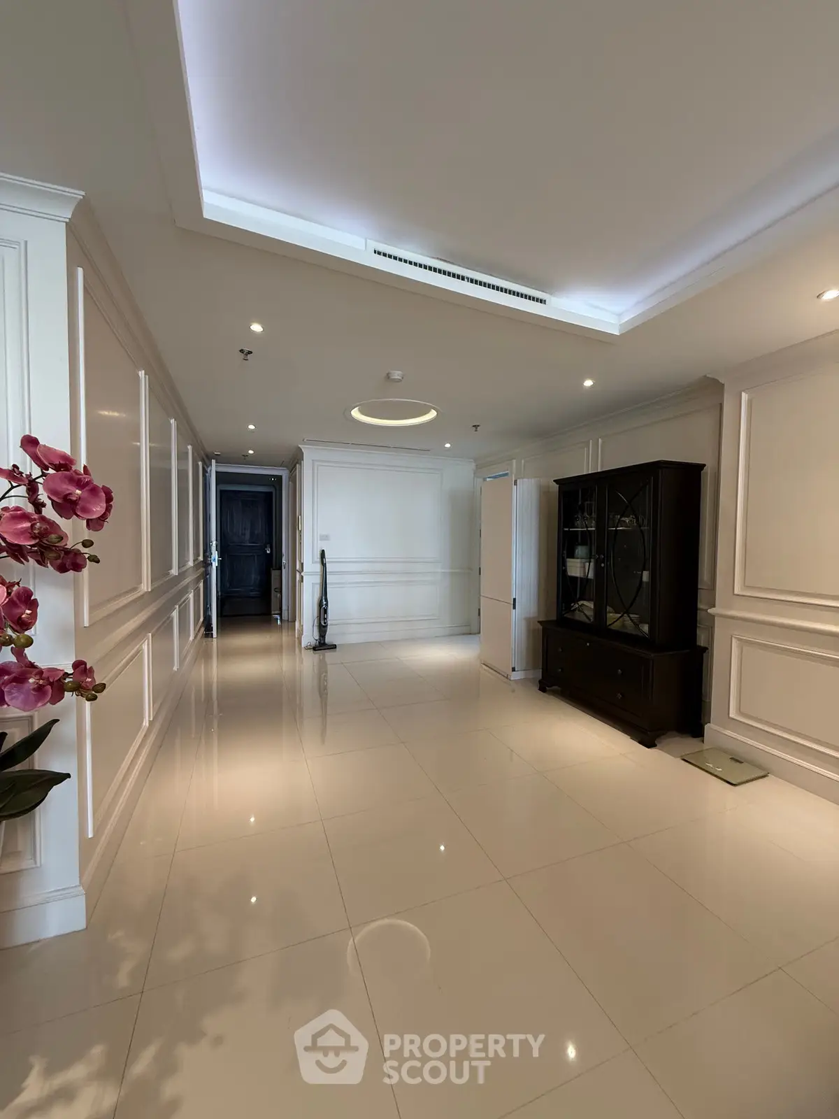 Elegant hallway with glossy tiles and classic decor in luxury home