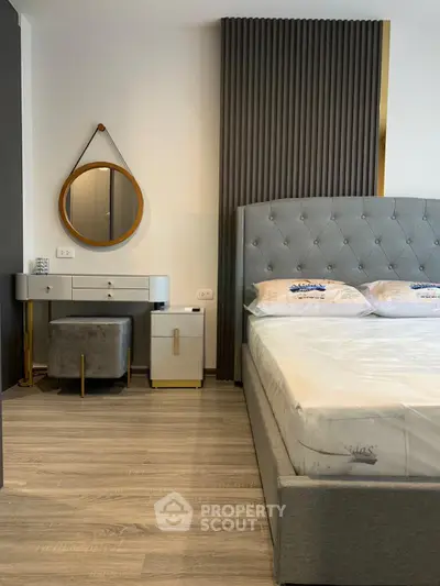 Modern bedroom with stylish decor and elegant furnishings, featuring a plush bed and chic vanity area.