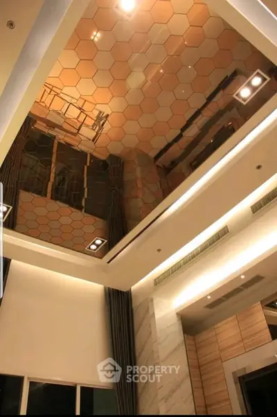Luxurious modern interior with stunning hexagonal ceiling design and elegant lighting