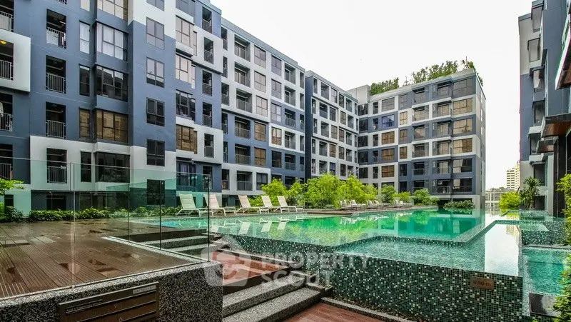 Luxurious modern apartment complex with stunning pool and lush greenery