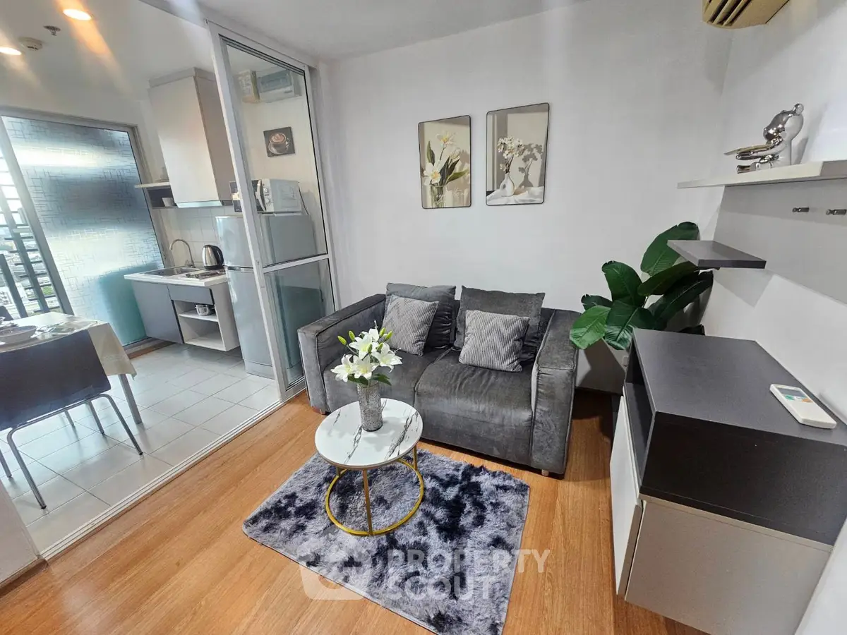 Chic modern living room with cozy sofa and open kitchen layout, perfect for urban living.