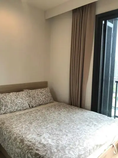 Cozy bedroom with elegant decor and balcony view in modern apartment