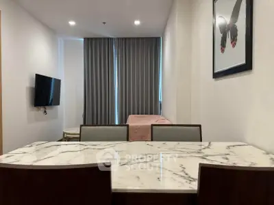 Modern living room with marble dining table and wall-mounted TV