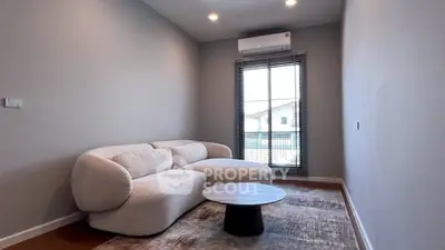 Modern living room with cozy sofa and stylish coffee table near window.