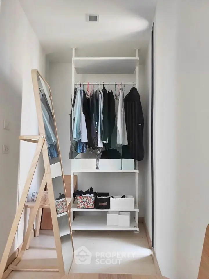 Spacious walk-in closet with modern shelving and full-length mirror in stylish home.