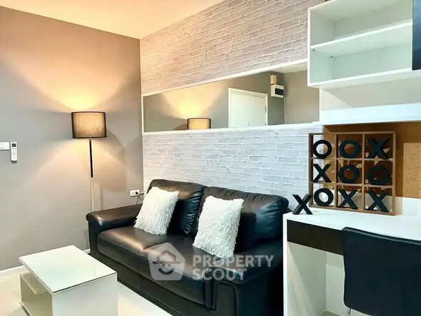 Modern living room with stylish black leather sofa and chic decor