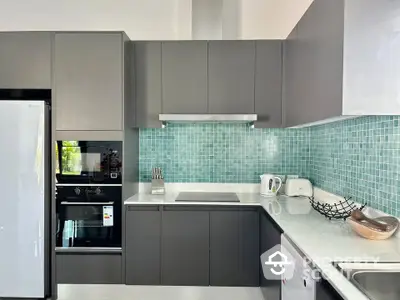 Modern kitchen with sleek cabinetry and stylish backsplash in contemporary home