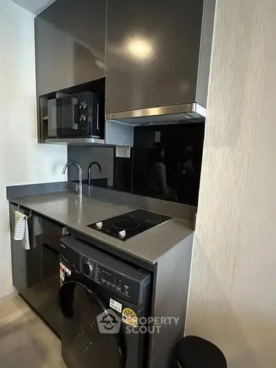 Modern compact kitchen with sleek appliances and efficient layout