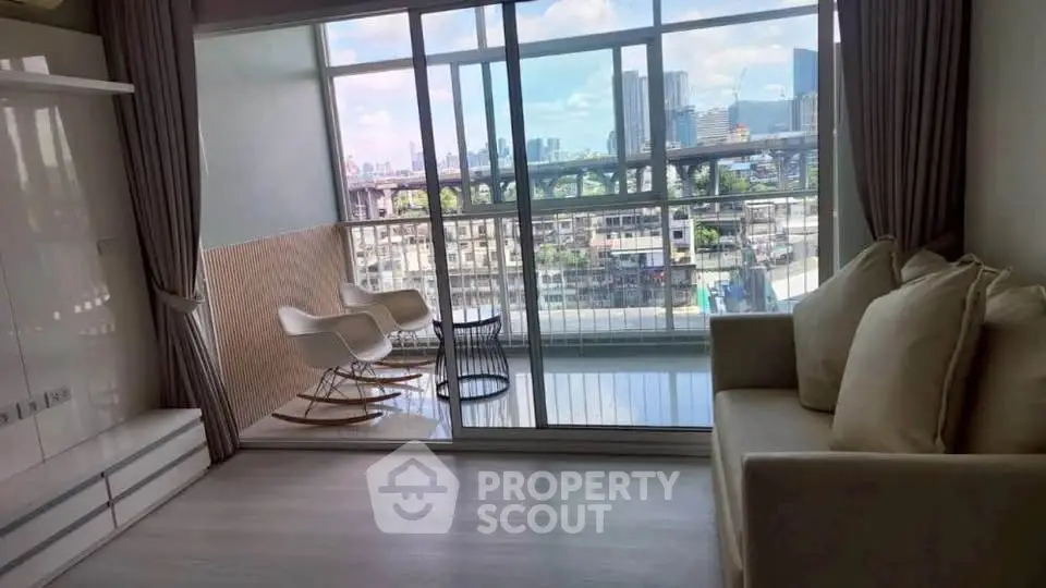 Modern living room with large windows offering stunning city view and cozy seating area.