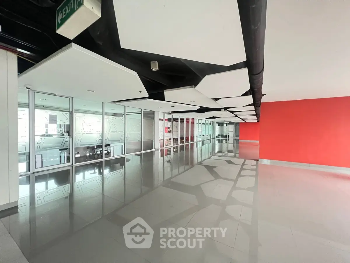 Spacious modern office corridor with sleek design and reflective flooring