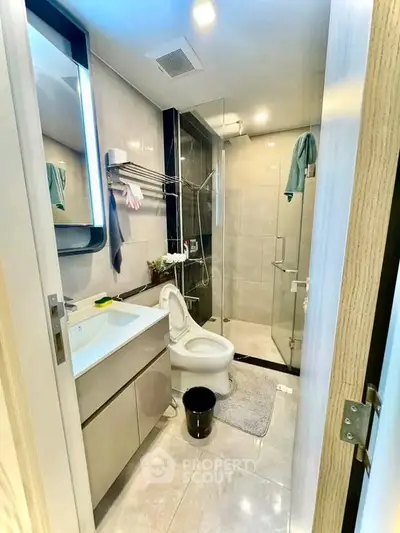 Modern bathroom with sleek fixtures and glass shower enclosure