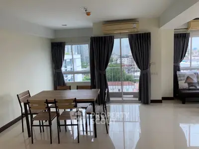Spacious living room with dining area and city view in modern apartment.