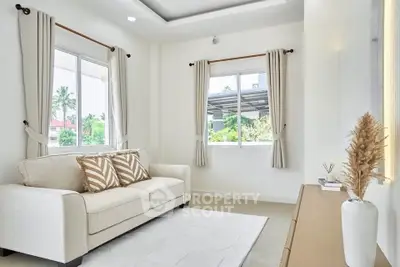 Bright and airy living room with modern decor and large windows.