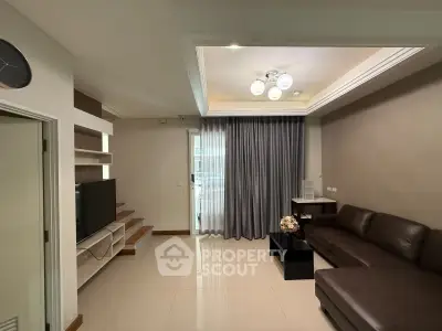 Modern living room with sleek furniture and elegant lighting, featuring a cozy sofa and entertainment area.