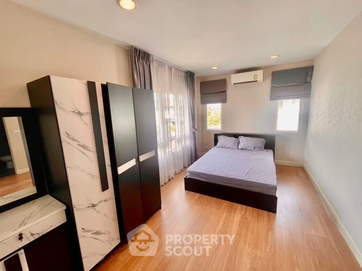 Spacious bedroom with modern furnishings and natural light