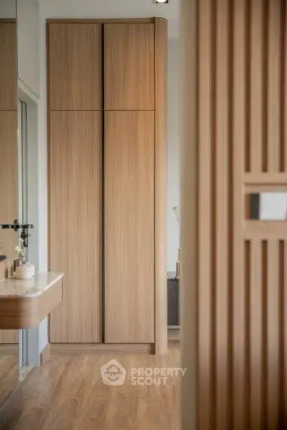 Modern wooden wardrobe in a stylish interior with elegant design and warm tones.