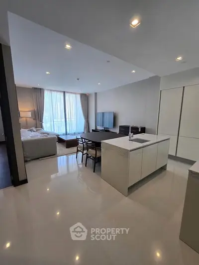 Spacious modern living room with open kitchen and large windows in luxury apartment.