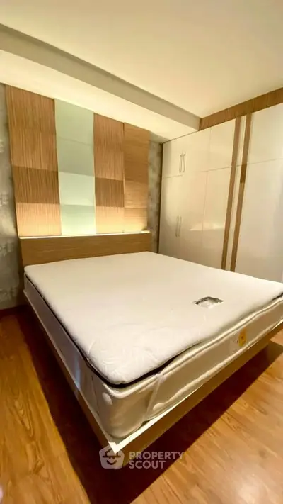 Modern bedroom with stylish wooden accents and built-in wardrobe