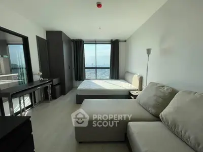 Modern bedroom with city view, featuring a cozy sofa and stylish decor in a high-rise apartment.