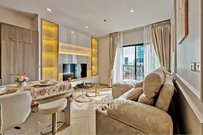Luxurious living room with elegant decor and city view from large window.