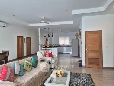 Spacious open-plan living room with modern kitchen and stylish decor