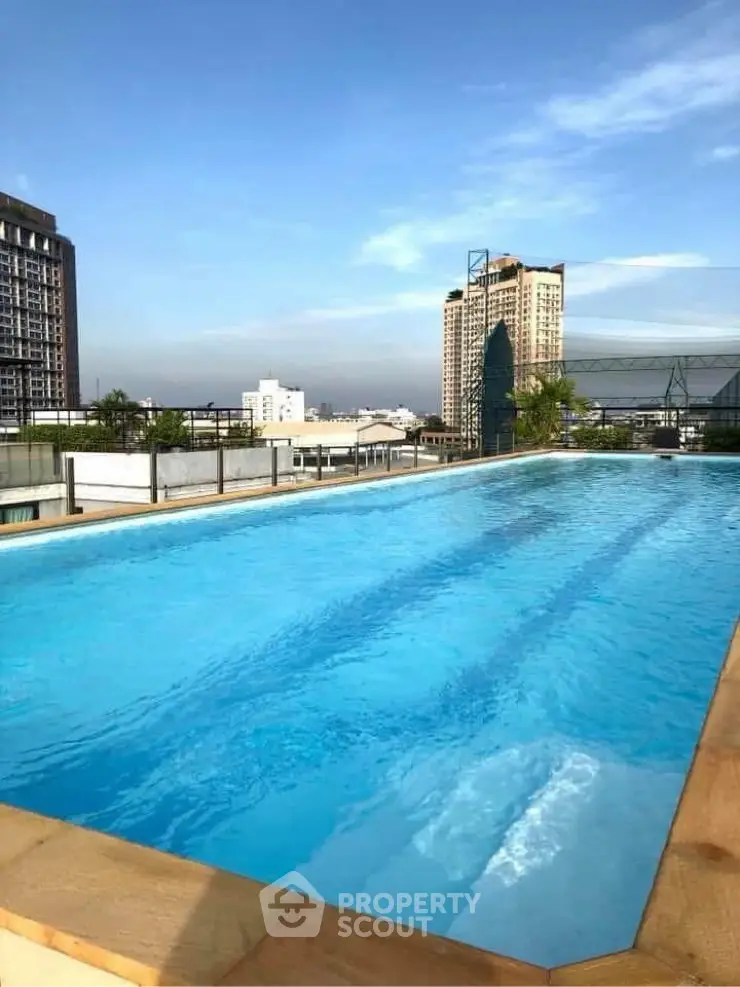 Stunning rooftop pool with city skyline views, perfect for relaxation and leisure.