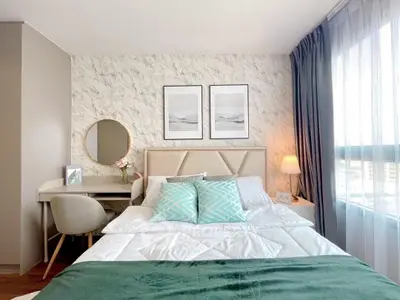 Chic bedroom with modern decor, large window, and stylish furnishings for a cozy living experience.