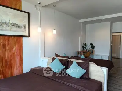 Spacious bedroom with modern decor and cozy lighting in a stylish apartment.