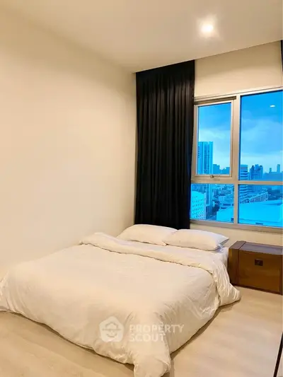 Modern bedroom with city view and elegant decor in urban apartment