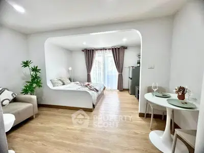 Modern studio apartment with open layout, featuring cozy bedroom and stylish dining area.