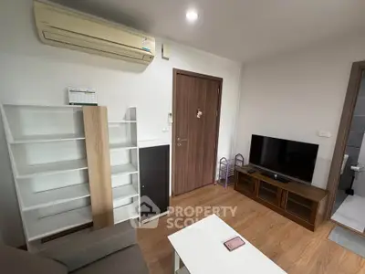 Cozy living room with modern furniture and air conditioning, perfect for relaxation.