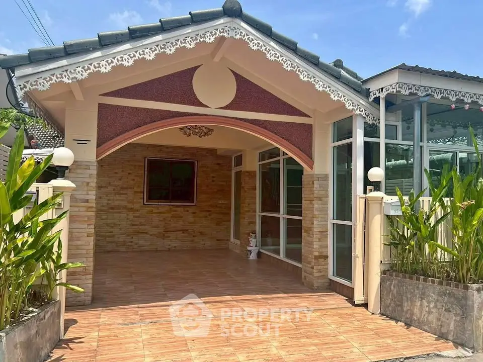 Charming single-story house with decorative facade and tiled driveway