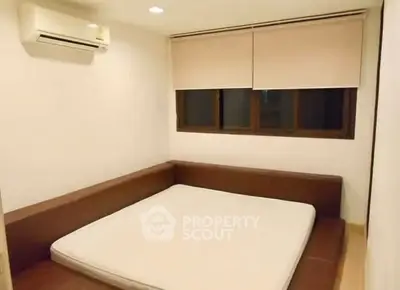 Cozy minimalist bedroom with built-in bed and air conditioning