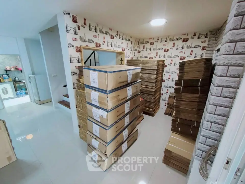 Spacious storage room with stacked boxes and modern decor, ideal for organizing and efficient use of space.