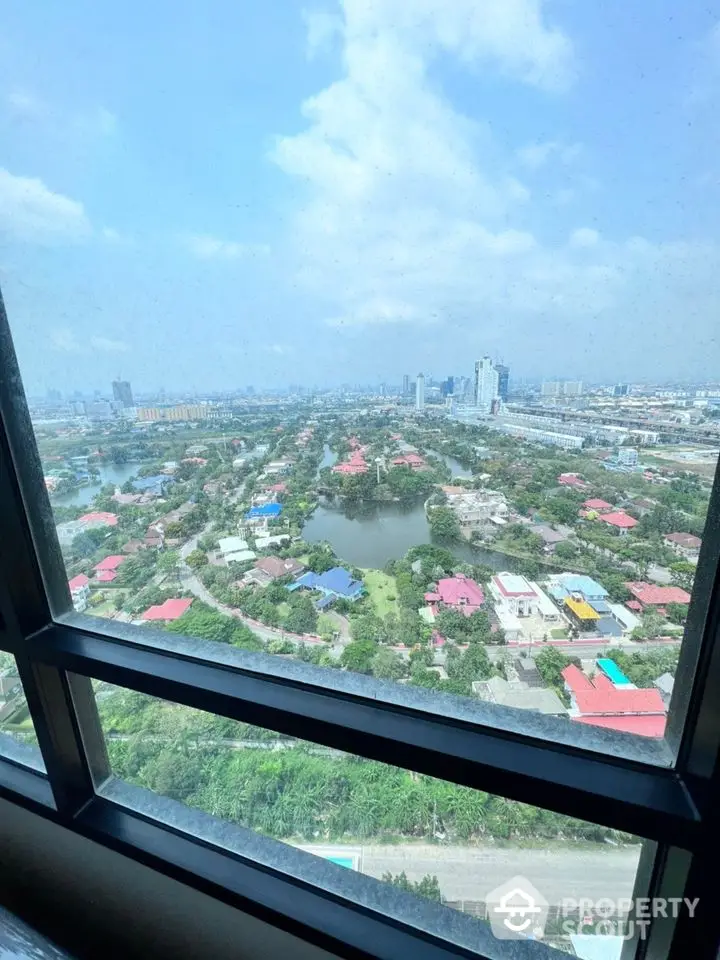 Breathtaking high-rise view from a modern apartment showcasing a panoramic cityscape with lush greenery and urban skyline, ideal for urban dwellers seeking a serene yet connected living space.