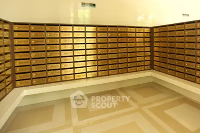 Spacious mailroom with organized mailboxes in a modern residential building.