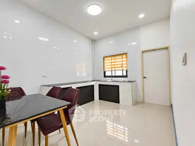 Spacious modern kitchen with sleek design and dining area