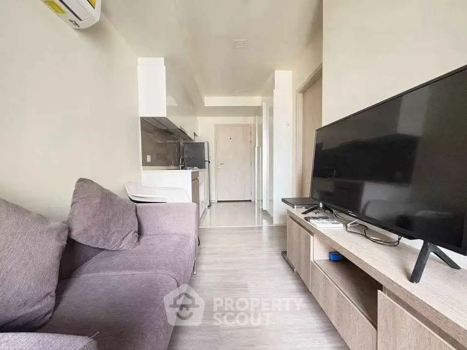Modern living room with sleek TV unit and cozy sofa in a stylish apartment