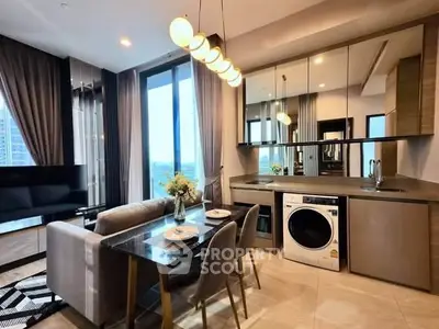 Modern open-layout kitchen and living room with stylish decor and appliances.