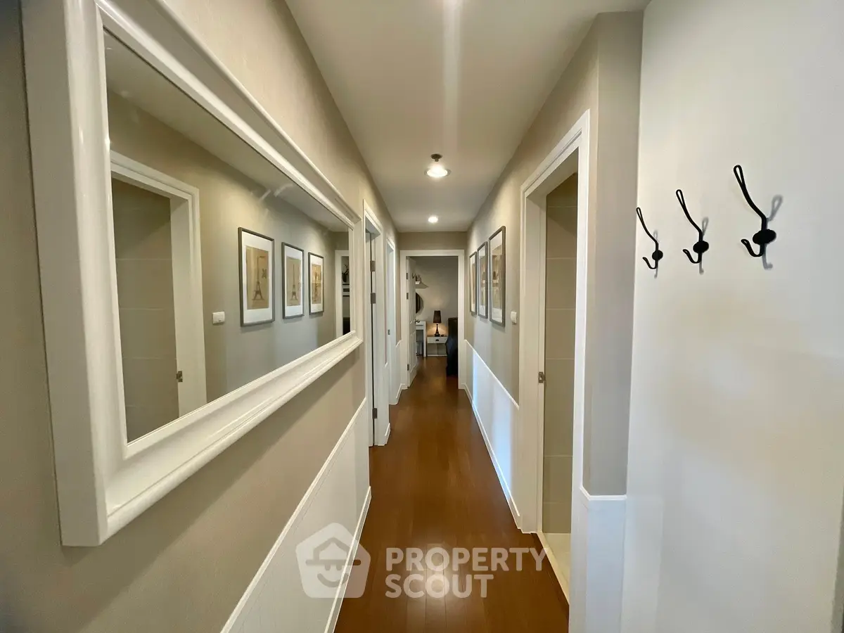 Spacious hallway with elegant decor and wooden flooring in modern home