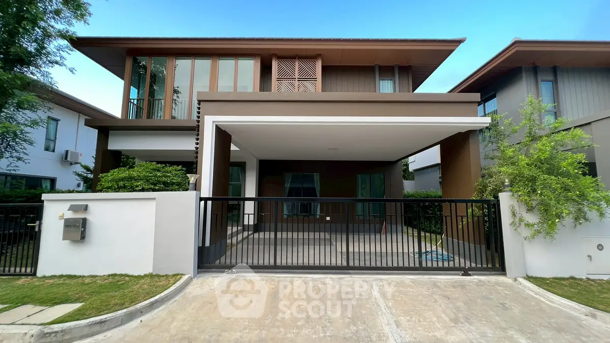 Modern two-story house with sleek design and spacious driveway in a serene neighborhood.